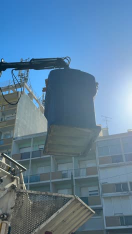 garbage truck lifting a waste container