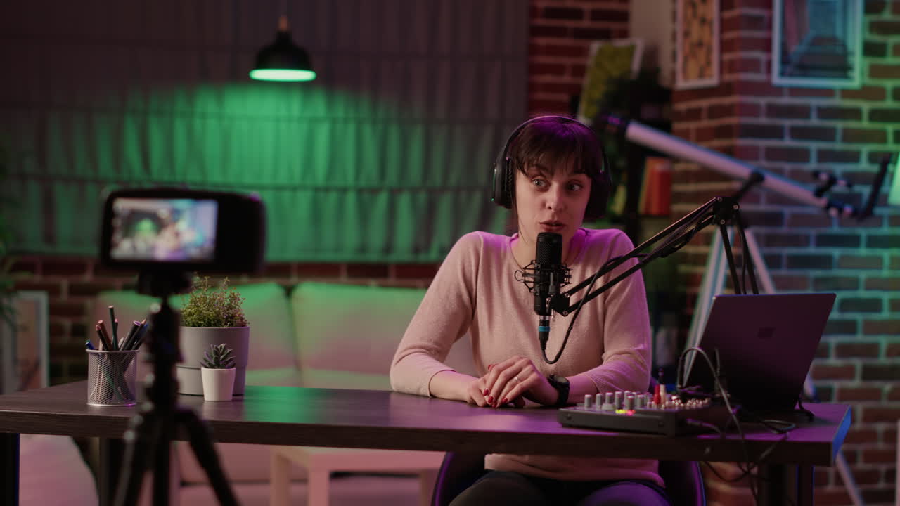 Woman content creator streaming live internet vlog using digital video camera