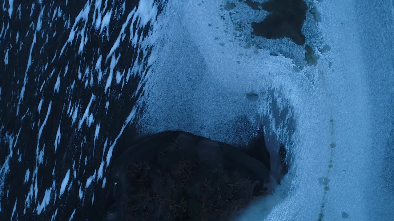 Super cold frozen lake in evening sunset blue light