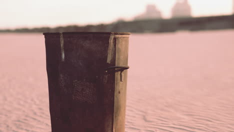 gray metal garbage bin or trash can on the beach