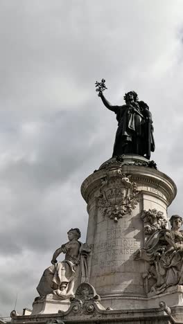 bronze statue of marianne with dynamic cloud backdrop