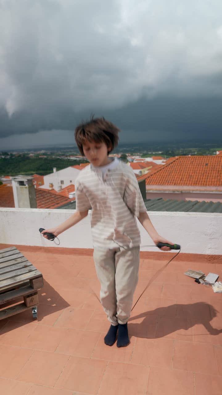 Boy Jumping Rope on Rooftop