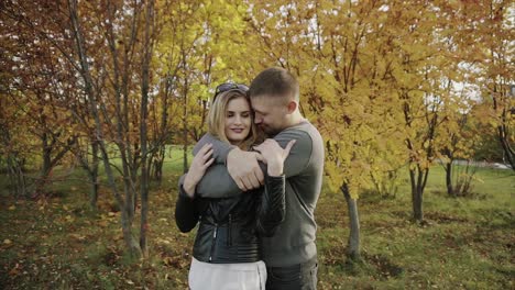 couple hugging in autumn park