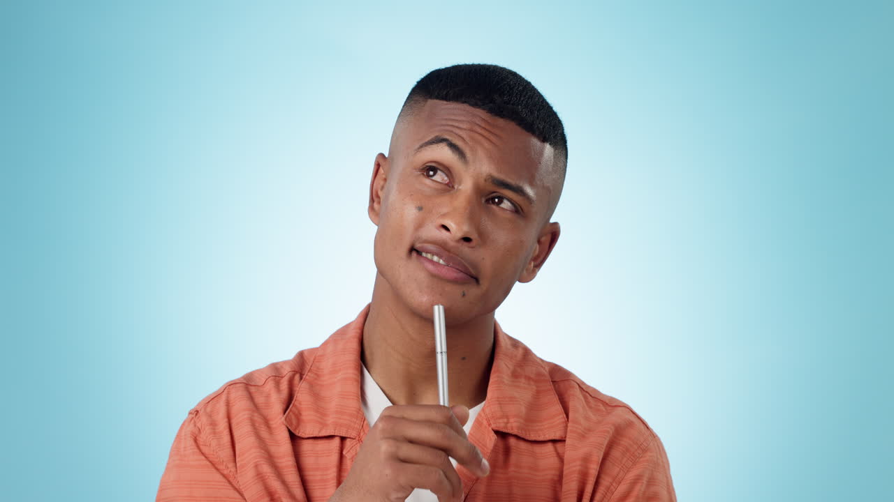 Man, thinking and ideas with pen in studio