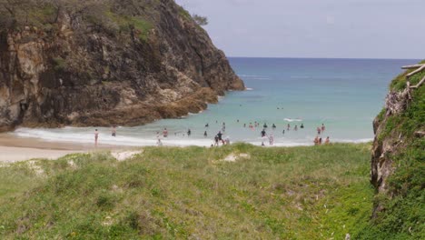 people swimming at the ocean of south gorge beach near north gorge walk at stradbroke island in queensland, australia