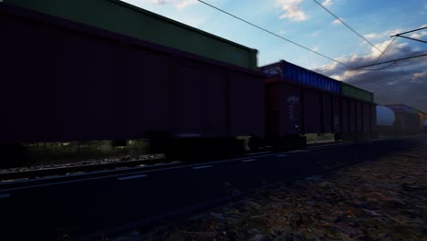 a freight train hauls shipping containers through the landscape, sunset and blue sky