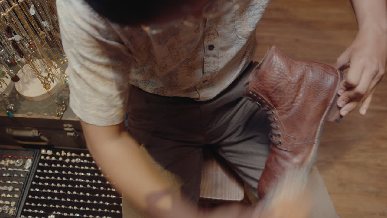 Cobbler Polishing Old Leather Shoes in Antique Shop