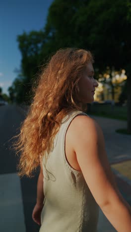 woman walking across a city street