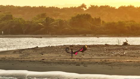 child kiteboarding on a tropical beach at sunset