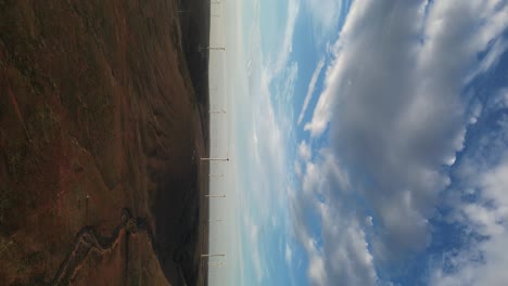 Wind-turbines-over-hills-at-sunset,-Australia