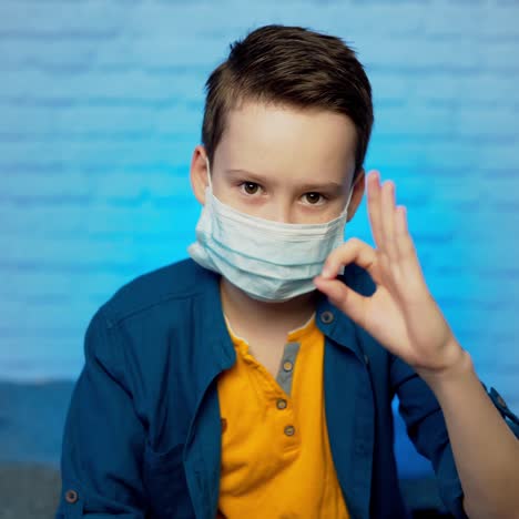 boy wearing medical face mask. self isolation. covid-19 virus epidemic pandemic. social distancing. health concept