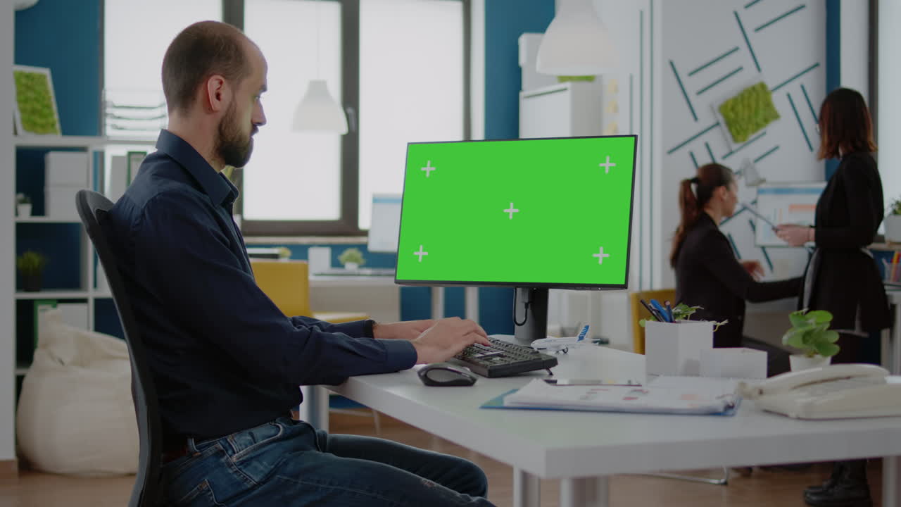Man with business job looking at horizontal green screen