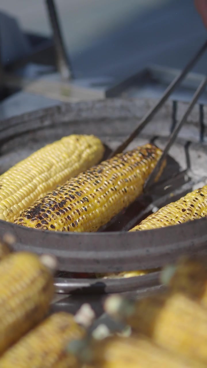 Chef Grilling Fresh Corn on the Cob on a Hot Charcoal Grill