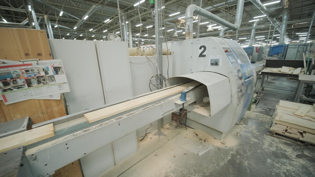 Wooden Plank Moving Through Industrial Woodworking Machine in Factory