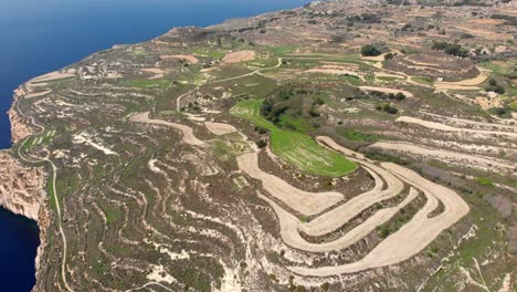 Pretty-aerial-drone-video-from-west-of-Malta,-Dingli,-Ras-id-Dawwara-surroundings-from-the-sky-in-the-middle-of-the-day