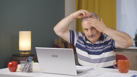 Home-office-worker-old-man-looks-at-camera-with-happy-and-smiling-face.