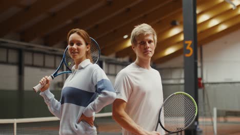 couple playing tennis indoor