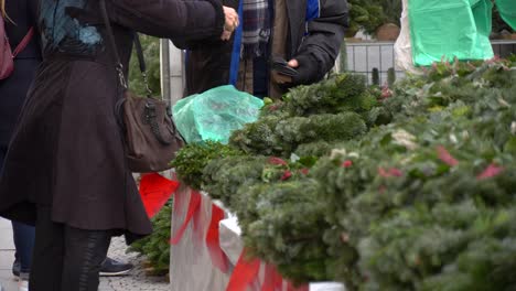 woman buying christmas wreath