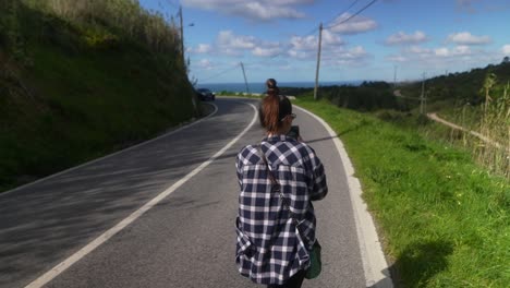 woman walking on a winding country road