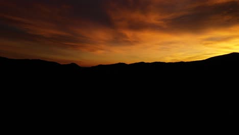 Mountain-Peaks-Sunrise-Horizon-Aerial-Pan-Shot-4K