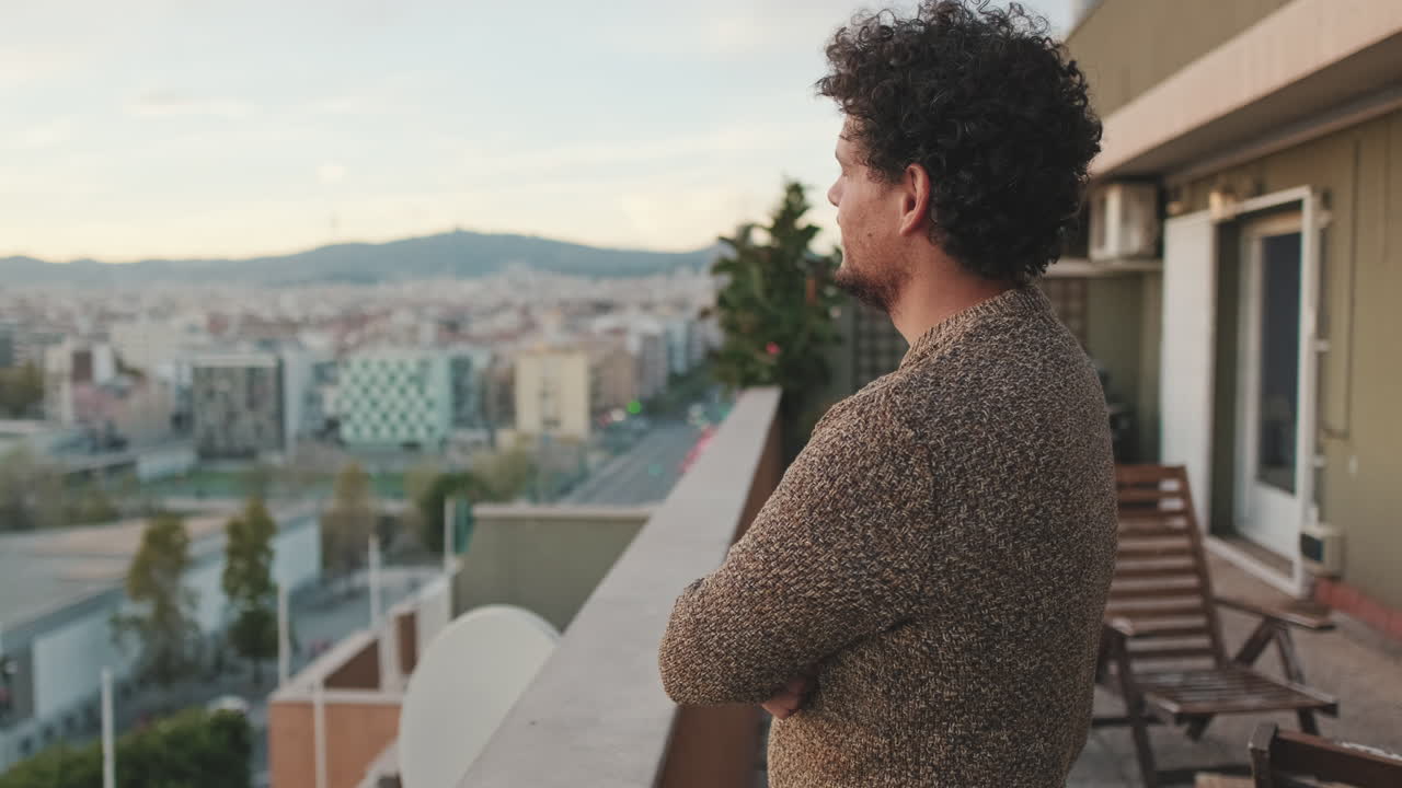Man on Balcony with City View