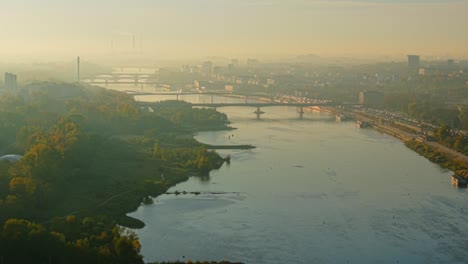 aerial view of cityscape with river and bridges on a foggy morning