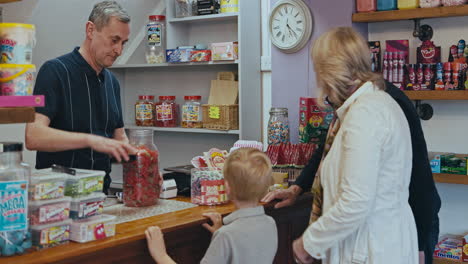 people buying candy at a candy store