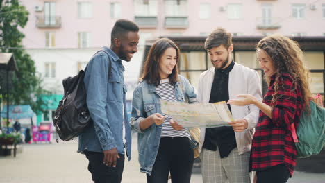 Group of friends looking at a map in a city