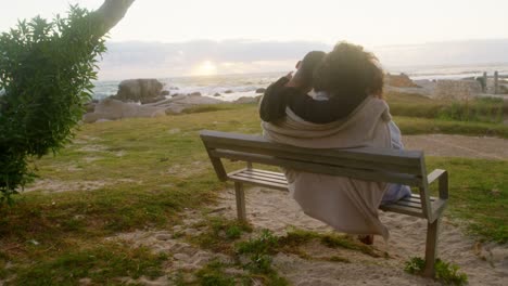 Couple-sitting-together-on-the-beach-4k
