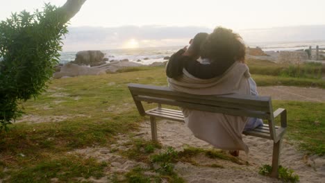 couple sitting together on the beach 4k