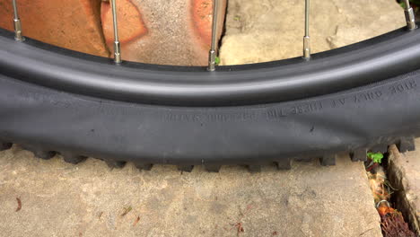 mountain bike tyre being pumped up, on a stone floor, close up