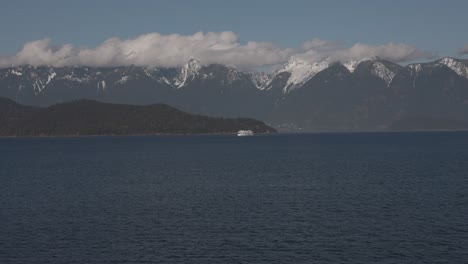 bc ferry boat navigating on sea water with mountains in background, british columbia