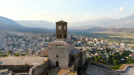 Drone-orbit-shot-4k-of-clock-of-Gjirokastra-castleGjirokastra-Castle-is-a-castle-in-Gjirokastra,-Albania