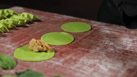 preparing green pasta with filling