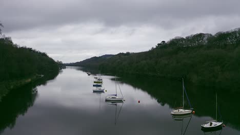 Beautiful-aerial-view,-footage-of-Rudyard-Lake-in-the-Derbyshire-Peak-District-Nation-Park,-popular-holiday,-tourist-attraction-with-boat-rides-and-water-sports-on-off,-peaceful,-calm-water