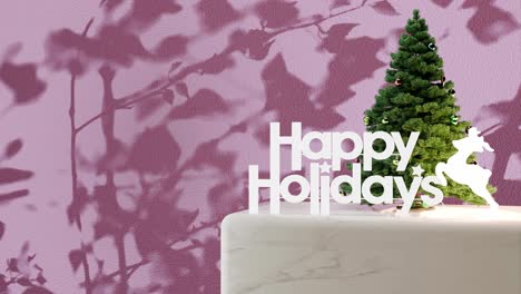 Small-Christmas-tree-with-"Happy-Holidays"-sign-on-marble-platform-with-pink-floral-shadow-background