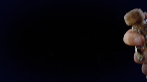 animation of colourful shapes over man opening champagne on black background