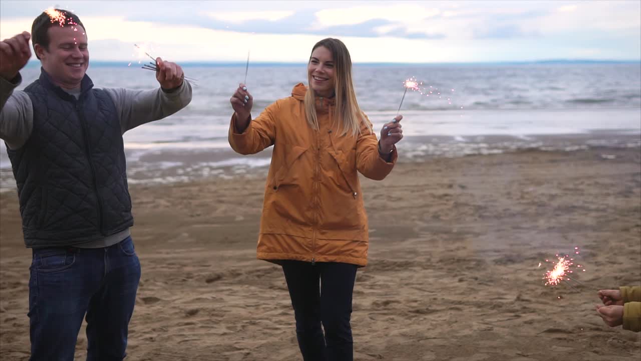 Family enjoying sparklers on the beach