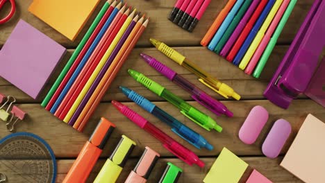 video of composition with colorful school items on wooden background