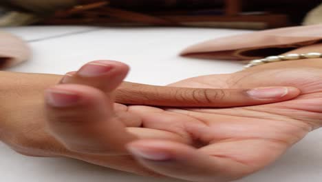 close-up of a woman's hand with a pearl bracelet