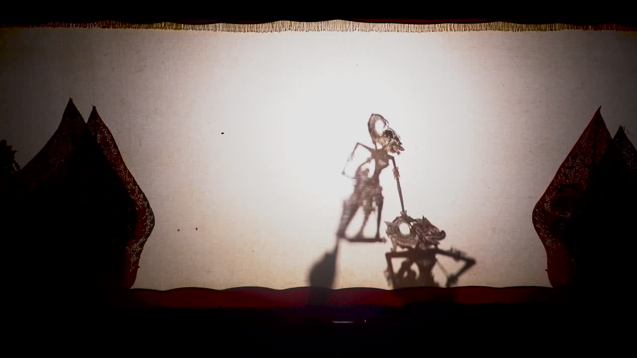 Wayang Kulit traditional Javanese puppet shadow performance Hanoman fights enemy