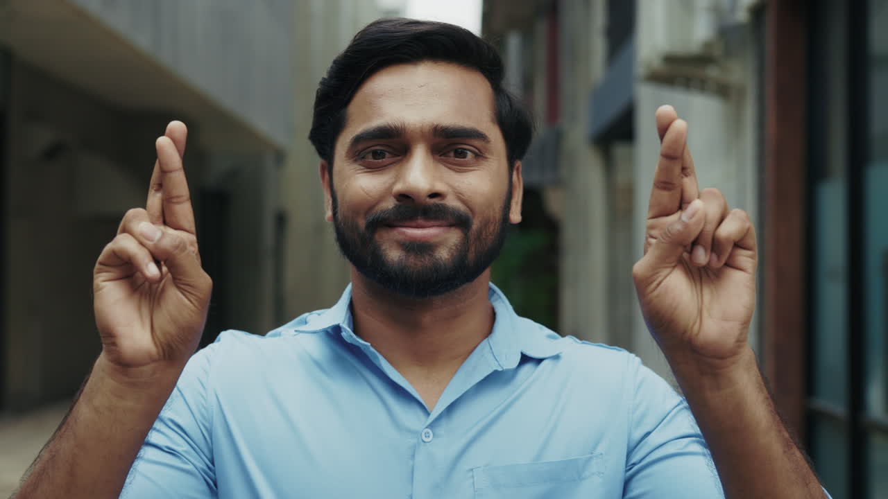 Man crossing his fingers for good luck