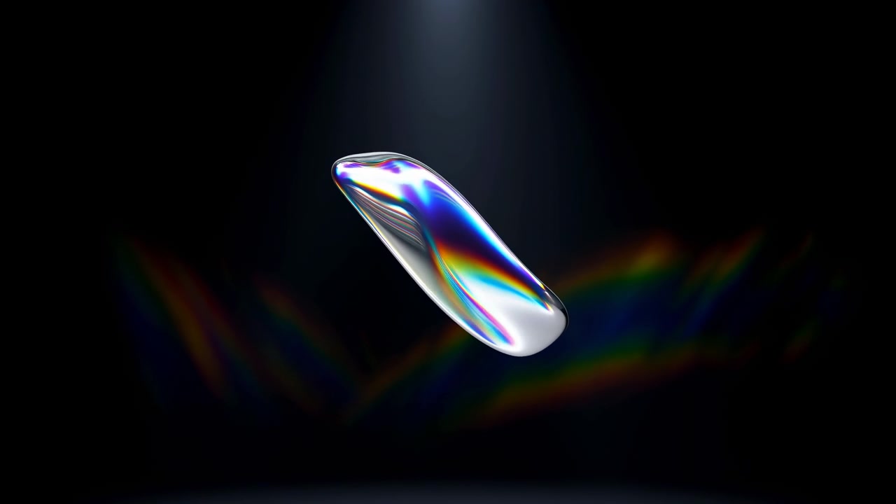 An abstract silver droplet floats against a dark background, illuminated by a soft overhead spotlight with subtle reflections and a clean minimal studio look