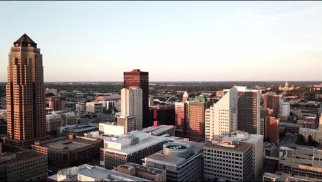 aerial drone footage at dusk of the tall, highrise office buildings in the state of iowa’s capital city, des moines