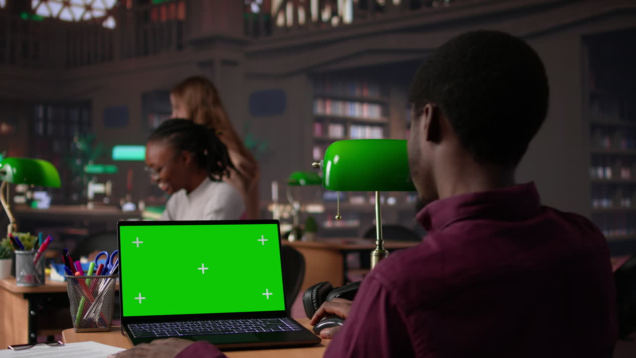 Vertical video college student looks at a copy space on laptop while collecting notes