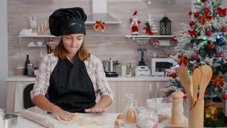 Portrait-of-children-putting-flour-ingredient-on-homemade-gingerbread-dough