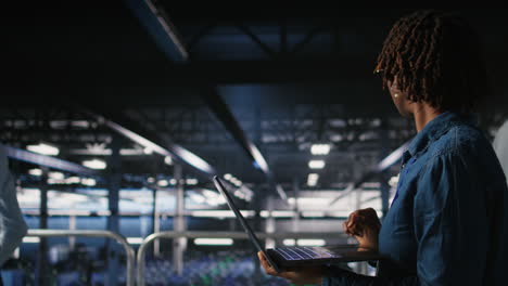 data center computer scientist doing maintenance tasks on laptop