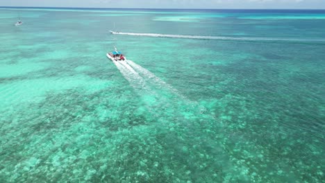 aerial drone follow of a catamaran full of tourists near the coast at saona island in the dominican republic