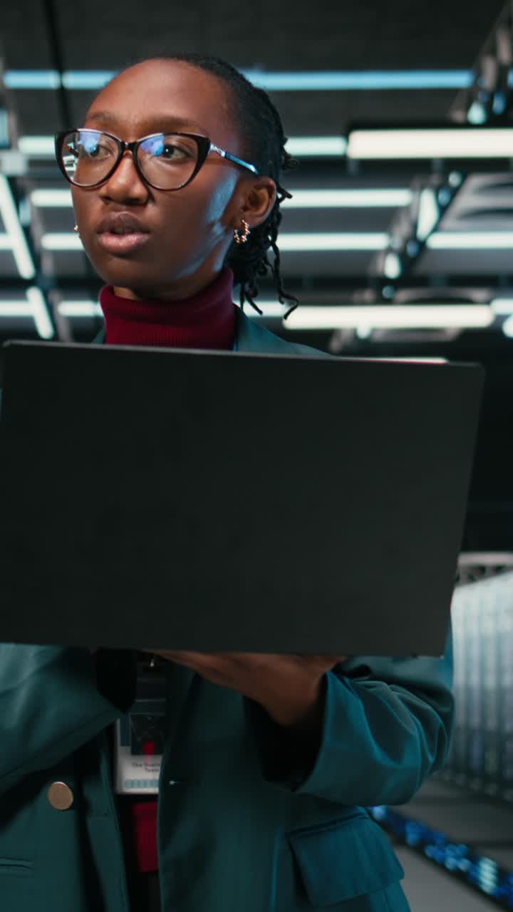 Vertical video Monitoring systems, laptop and female programmer in AR simulation data center