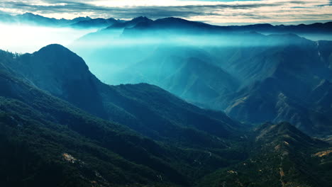 gorgeous mountains in blue mist. amazing view of the mountain range in california overgrown with greenery. top view.